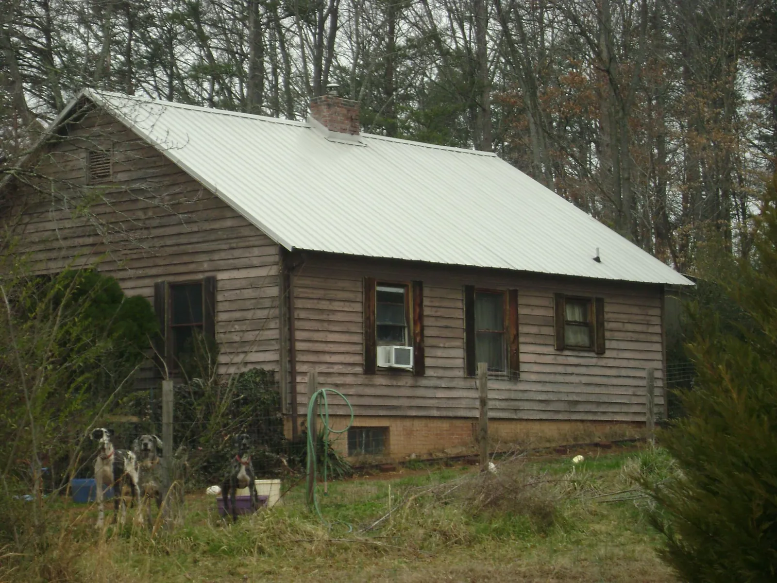 White metal roof on an old wood sided farmhouse, from a Metal Roof Installation job in Doylestown